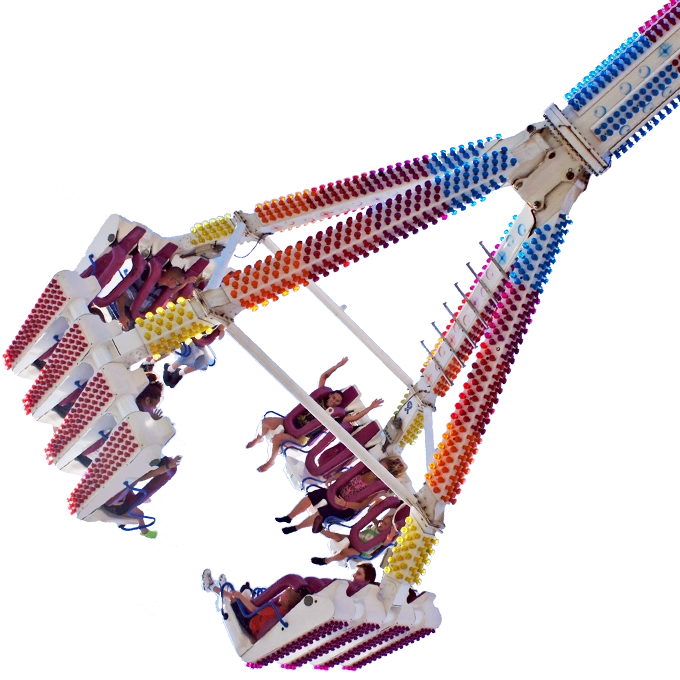 Colorful midway carnival ride glowing at night during Sacred Heart Festival